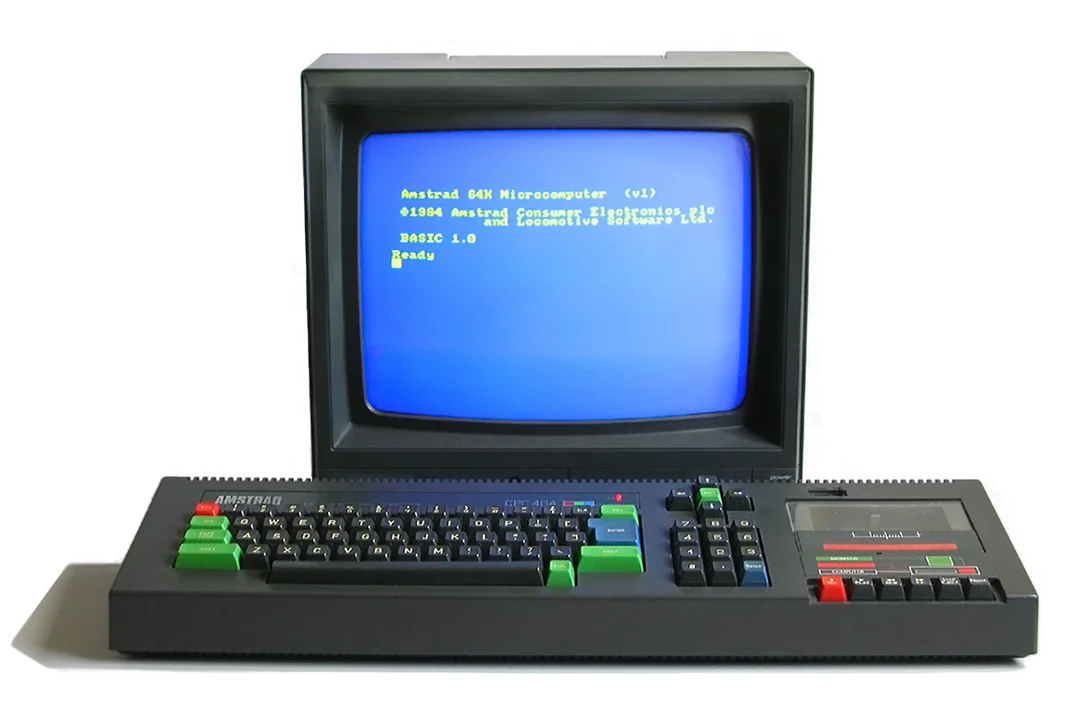 An Amstrad CPC 464 with its colour monitor showing the blue BASIC start-up screen