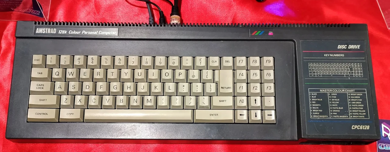 An Amstrad CPC 6128 keyboard unit with its built-in disc drive