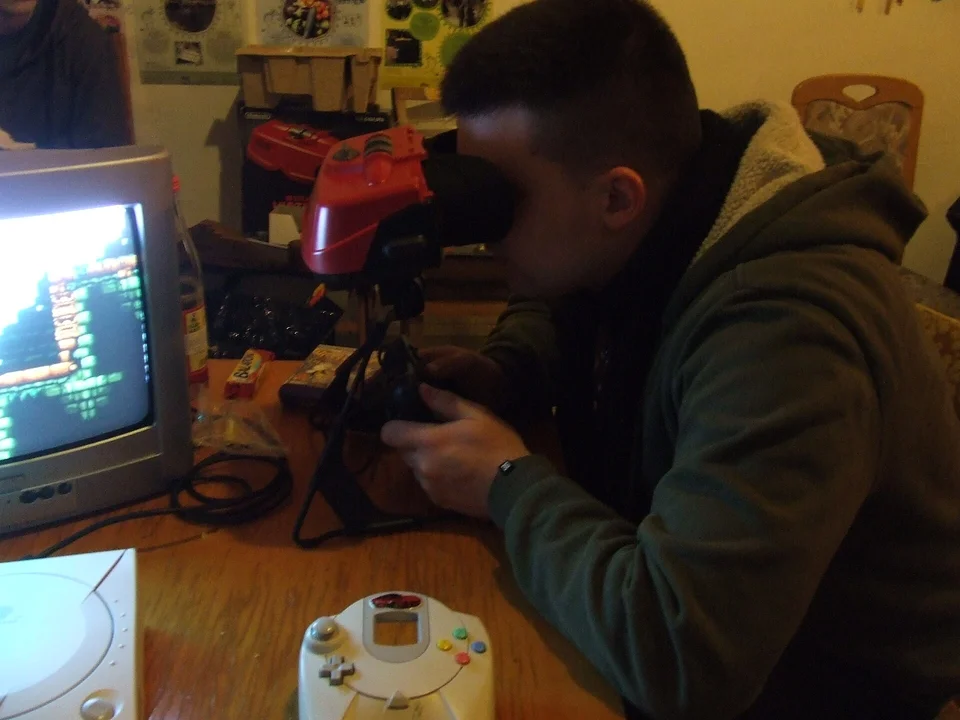A Nintendo Virtual Boy console on its tabletop stand, red lens visor facing forward