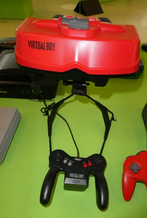 A Nintendo Virtual Boy console and controller displayed side on
