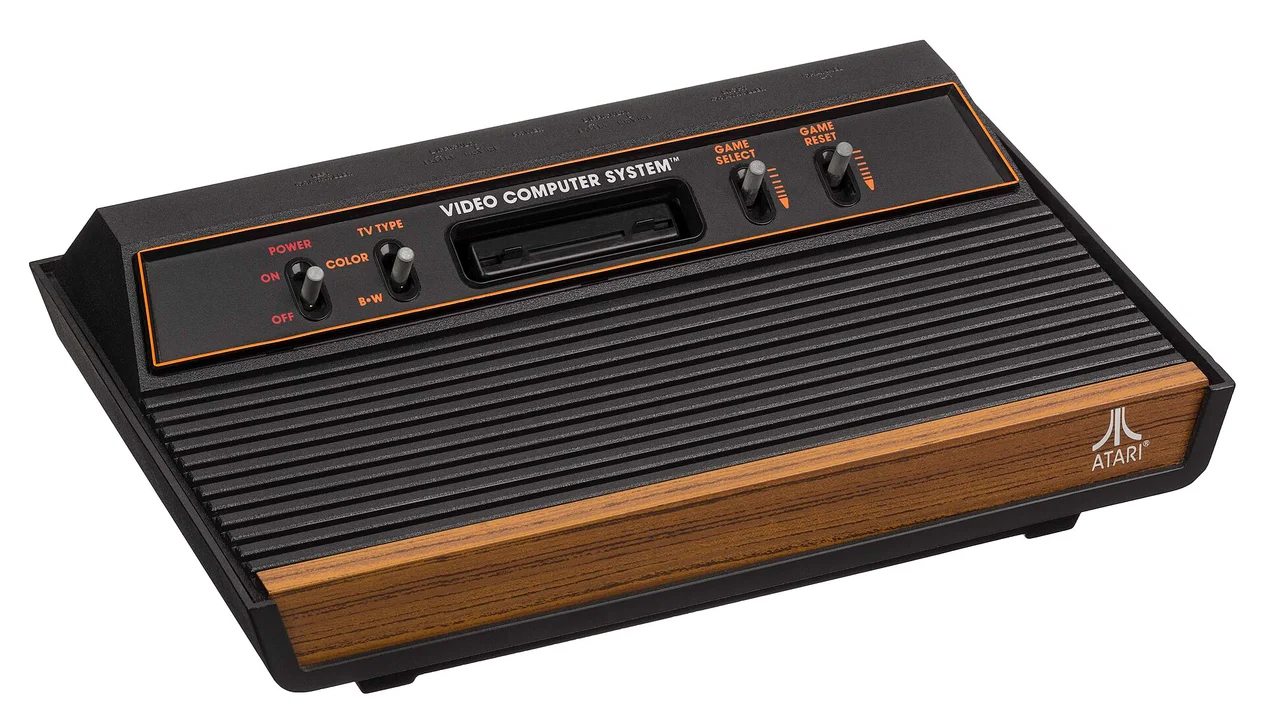 An Atari 2600 console with its woodgrain front panel and four switches